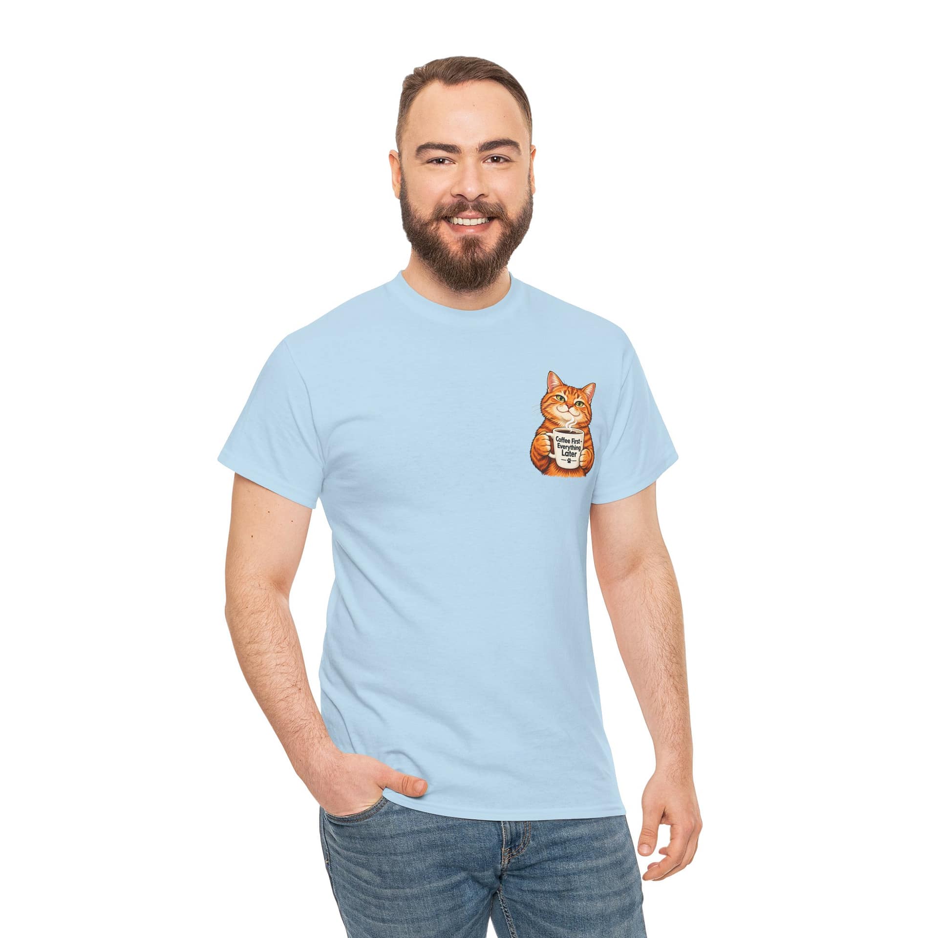 Cute orange cat holding a ‘But First Coffee’ mug printed on a unisex T‑shirt