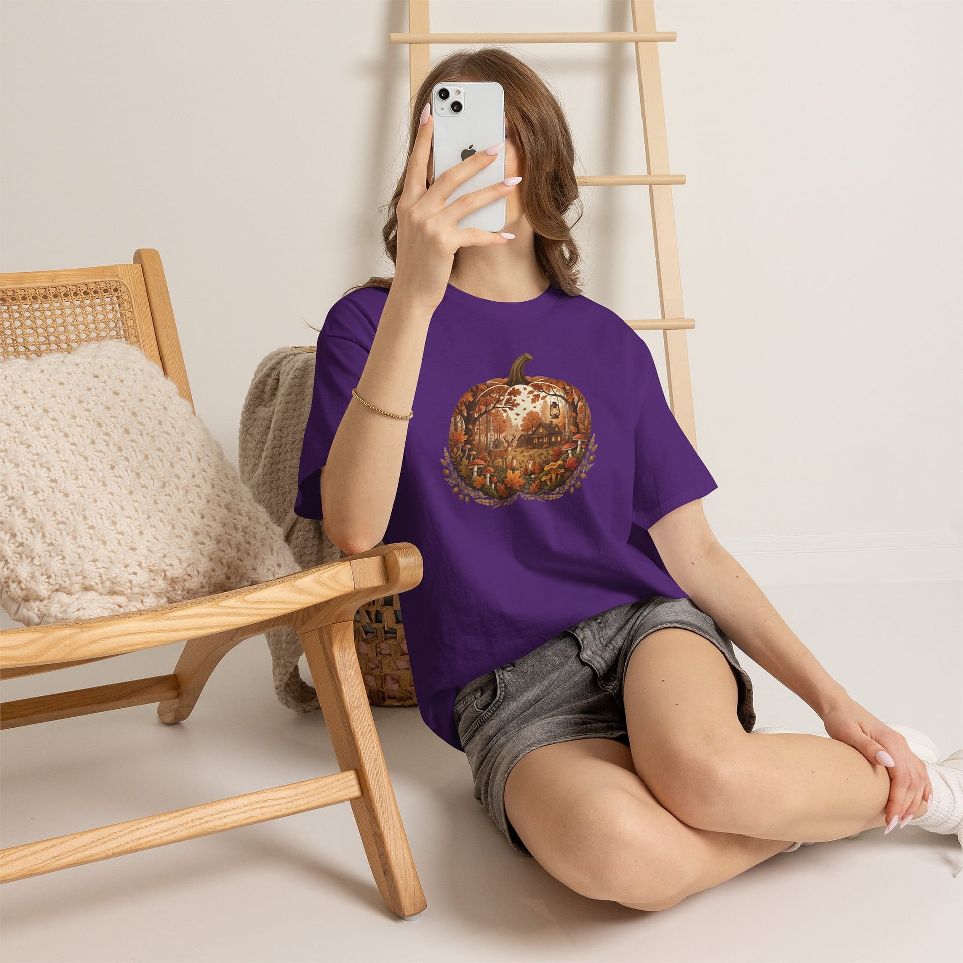 Model wearing Autumn Pumpkin Scene T‑Shirt with cosy fall pumpkin artwork