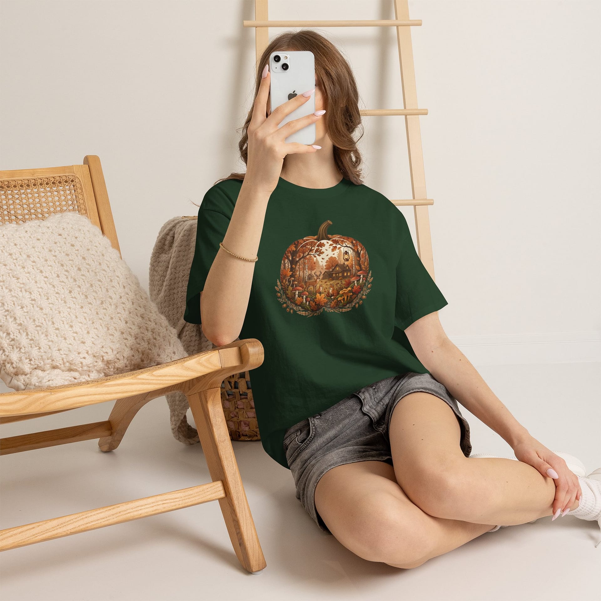 Model wearing Autumn Pumpkin Scene T‑Shirt with cosy fall pumpkin artwork