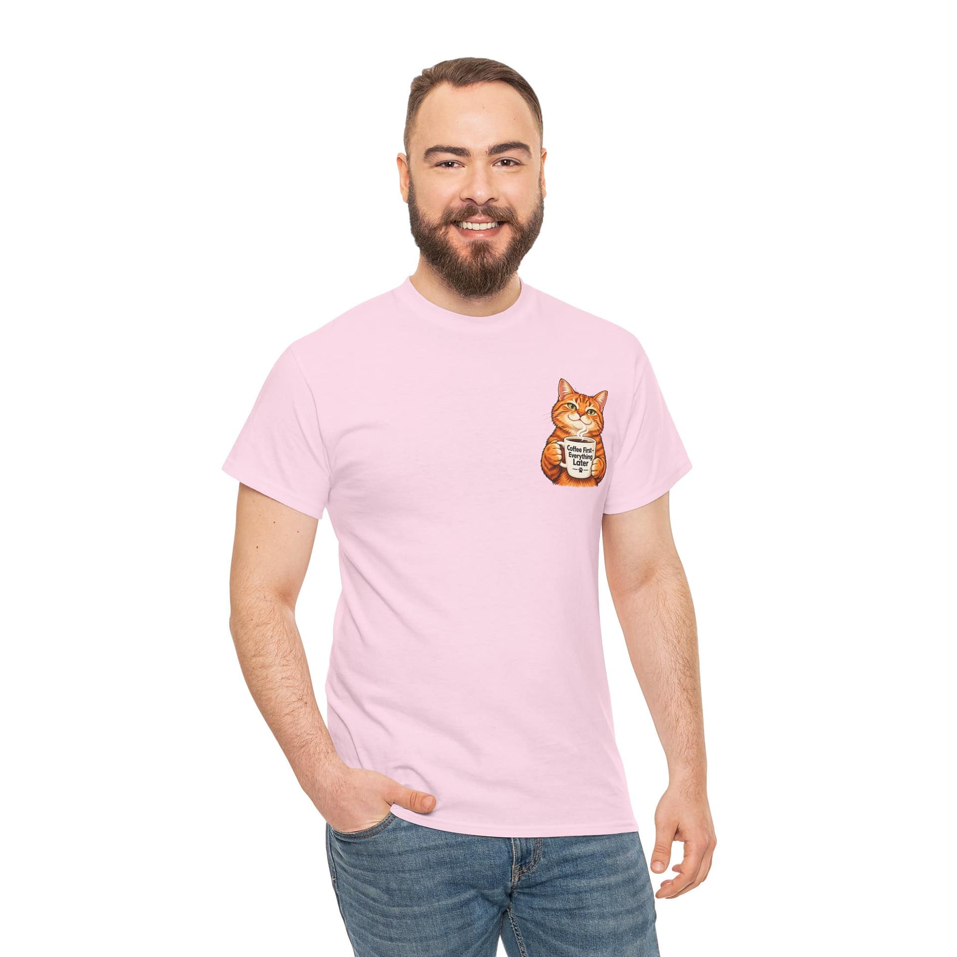 Cute orange cat holding a ‘But First Coffee’ mug printed on a unisex T‑shirt