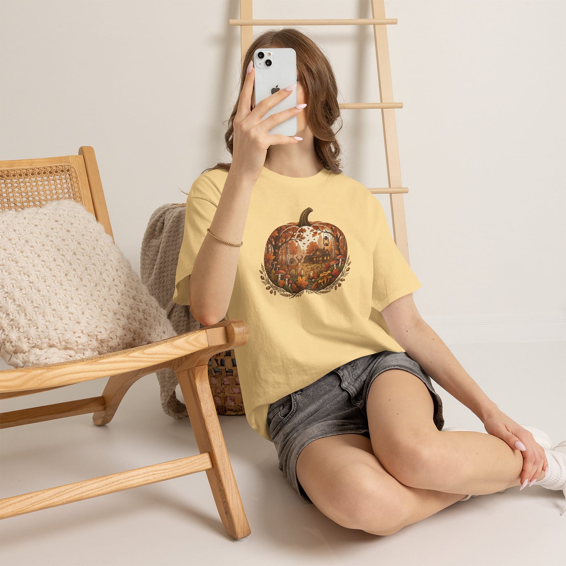 Model wearing Autumn Pumpkin Scene T‑Shirt with cosy fall pumpkin artwork