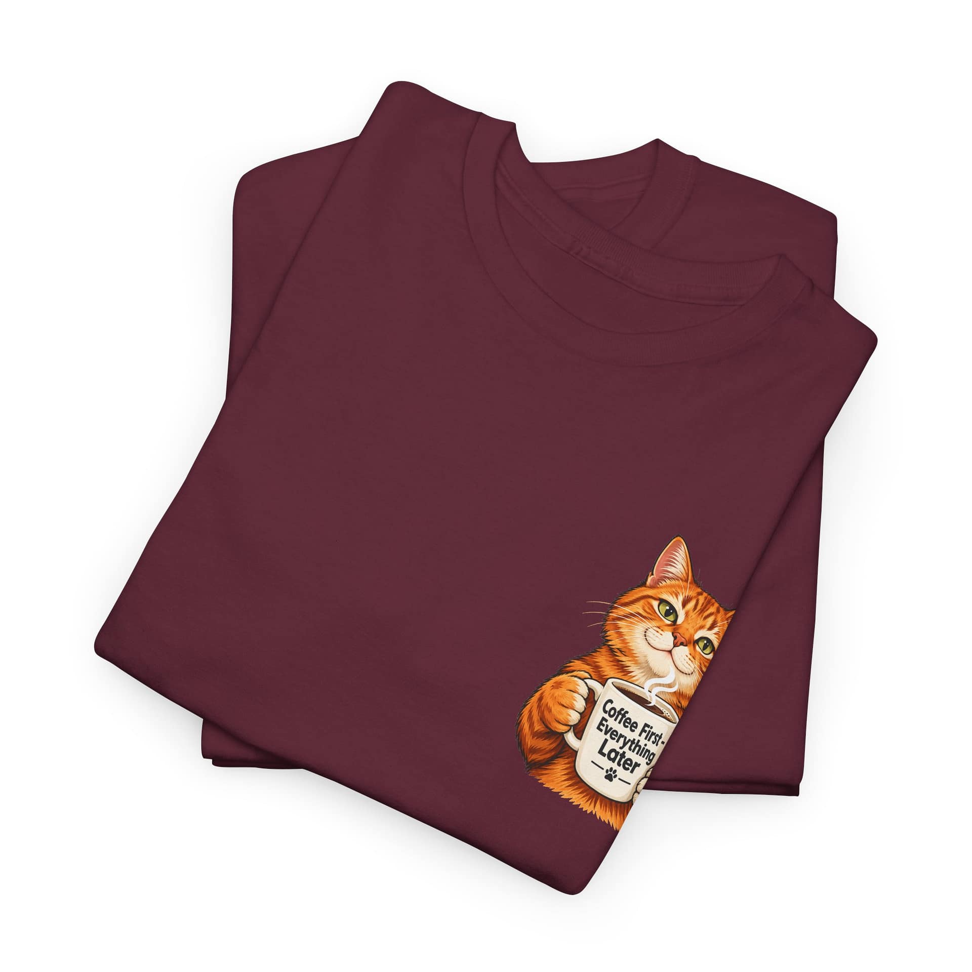 Close‑up of orange cat holding coffee mug graphic on T‑shirt
