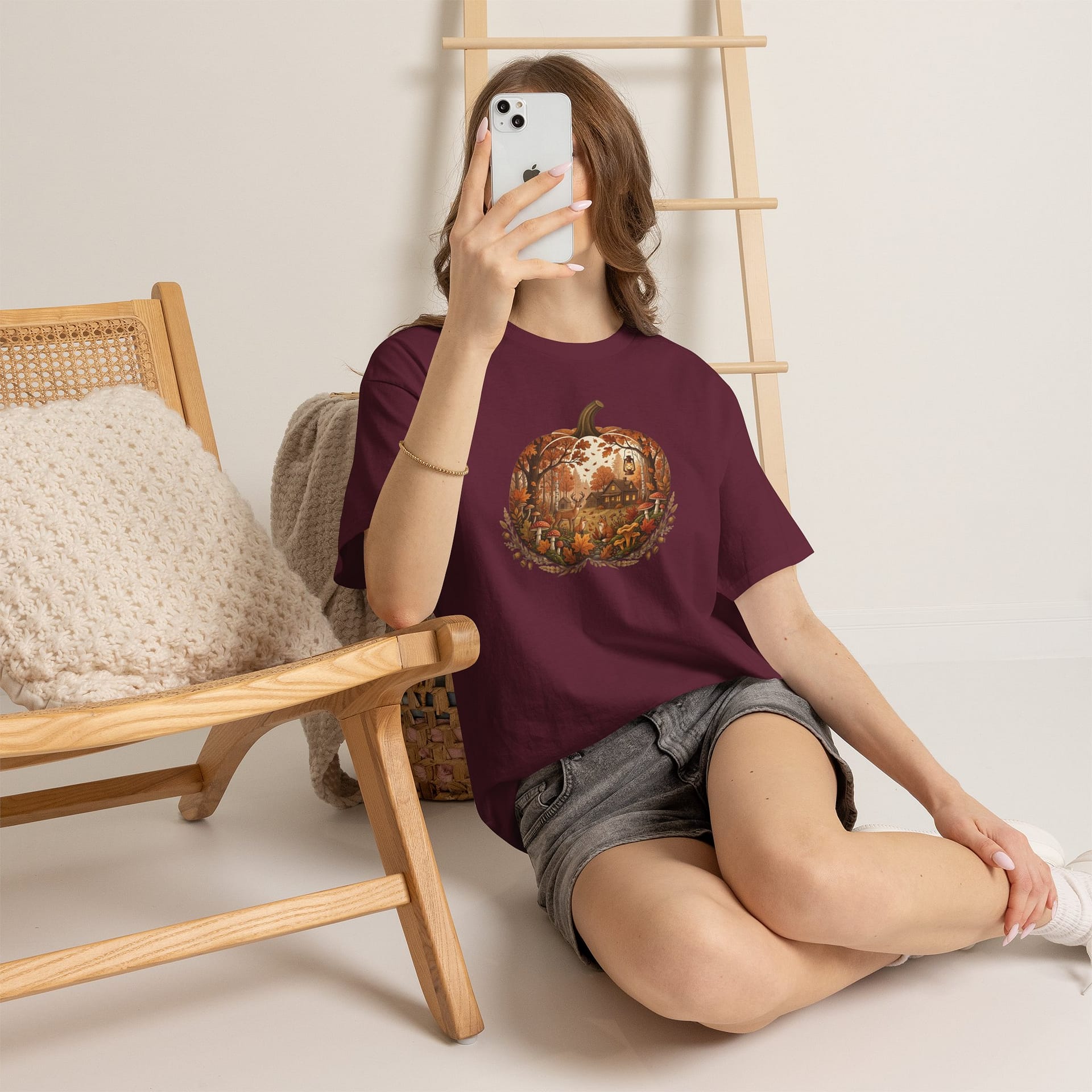 Model wearing Autumn Pumpkin Scene T‑Shirt with cosy fall pumpkin artwork
