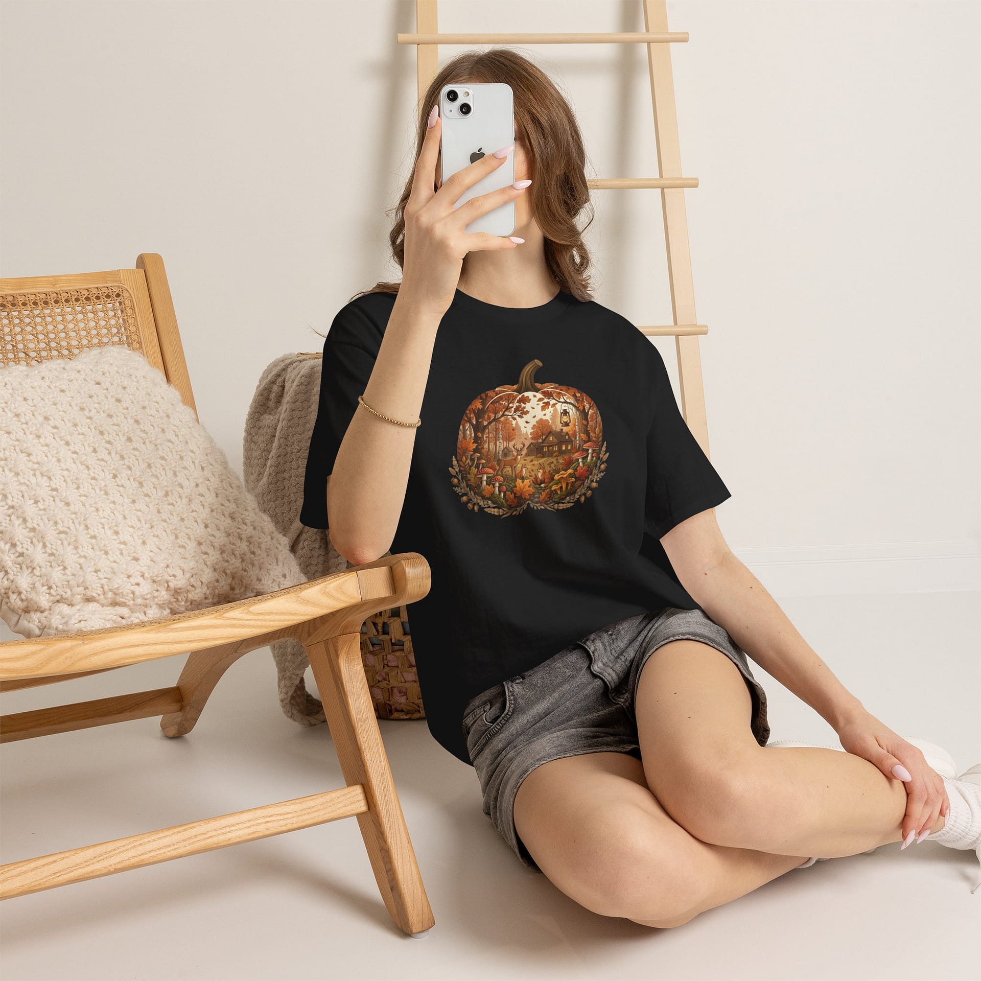 Model wearing Autumn Pumpkin Scene T‑Shirt with cosy fall pumpkin artwork
