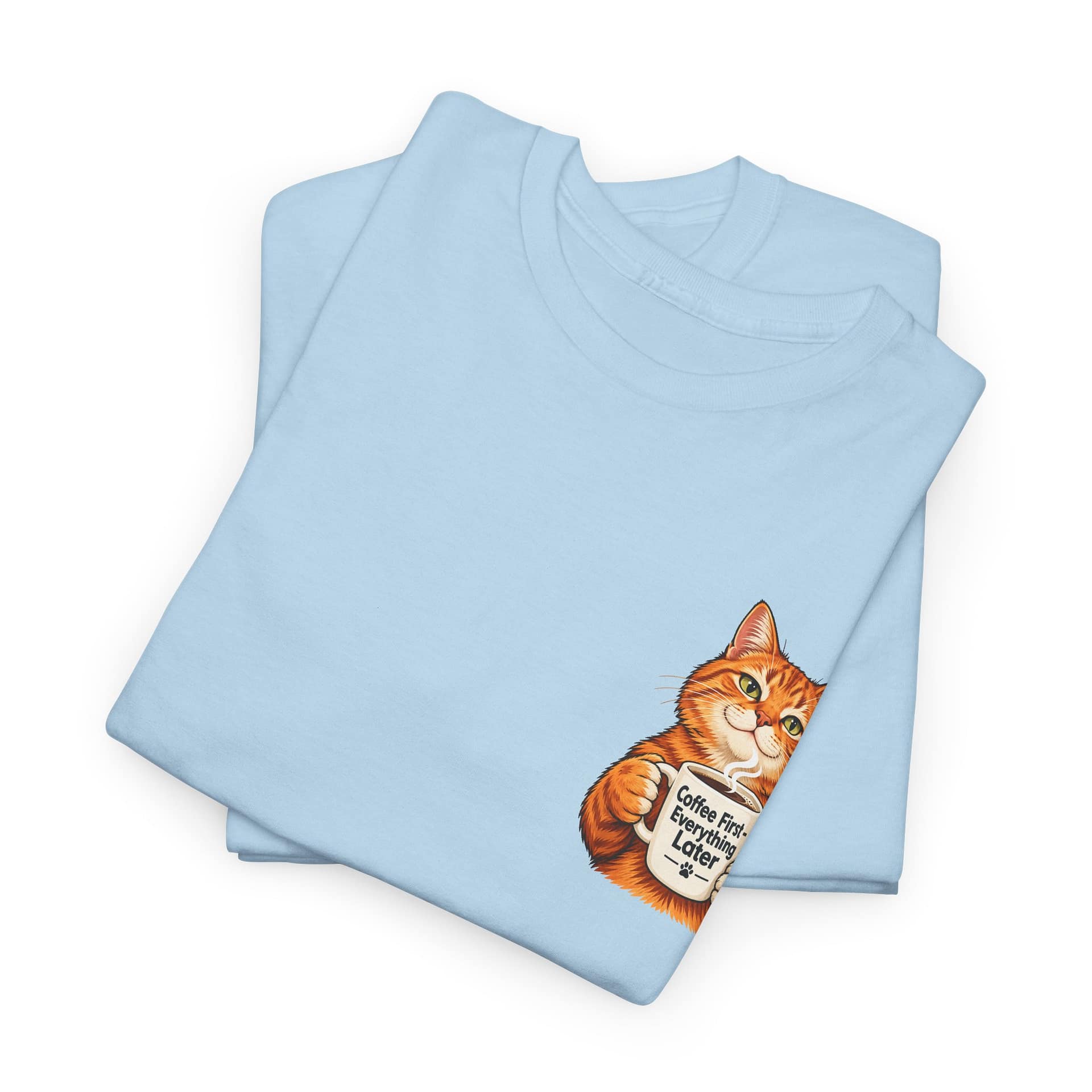 Close‑up of orange cat holding coffee mug graphic on T‑shirt