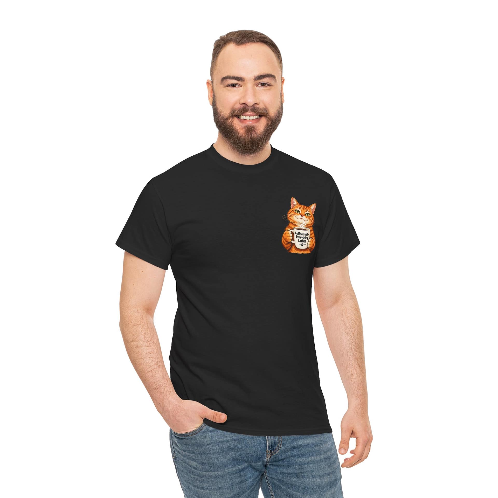 Cute orange cat holding a ‘But First Coffee’ mug printed on a unisex T‑shirt