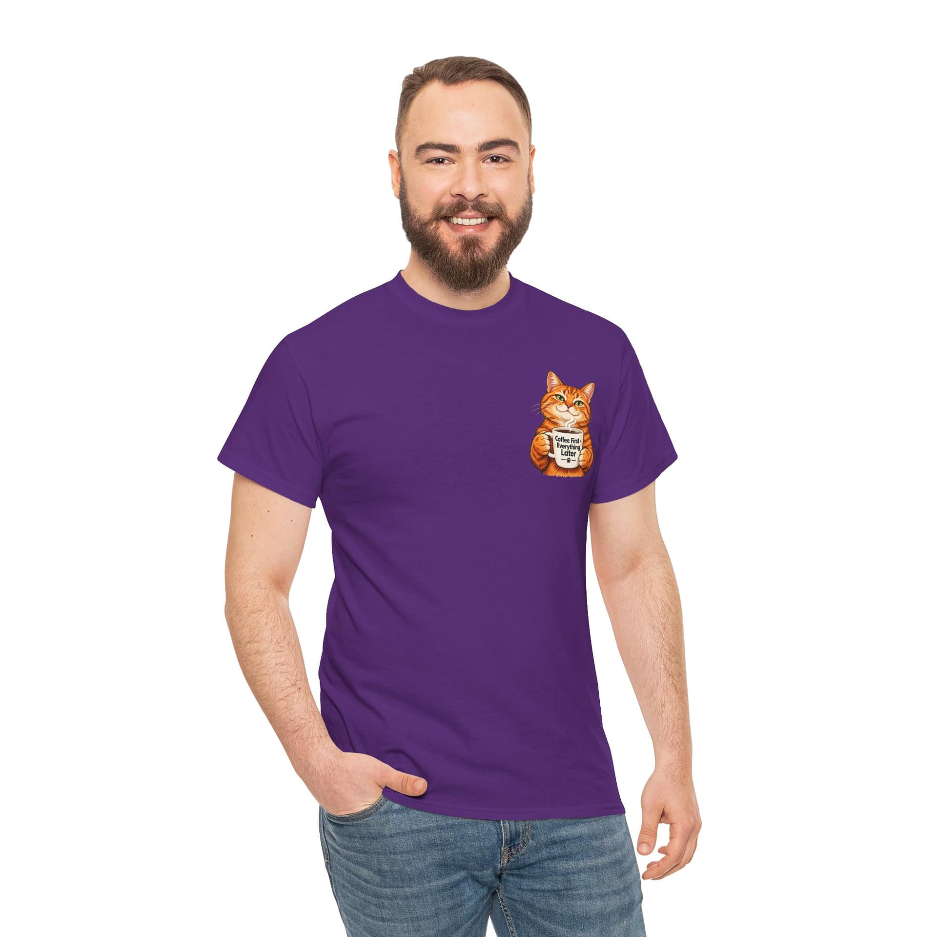 Cute orange cat holding a ‘But First Coffee’ mug printed on a unisex T‑shirt