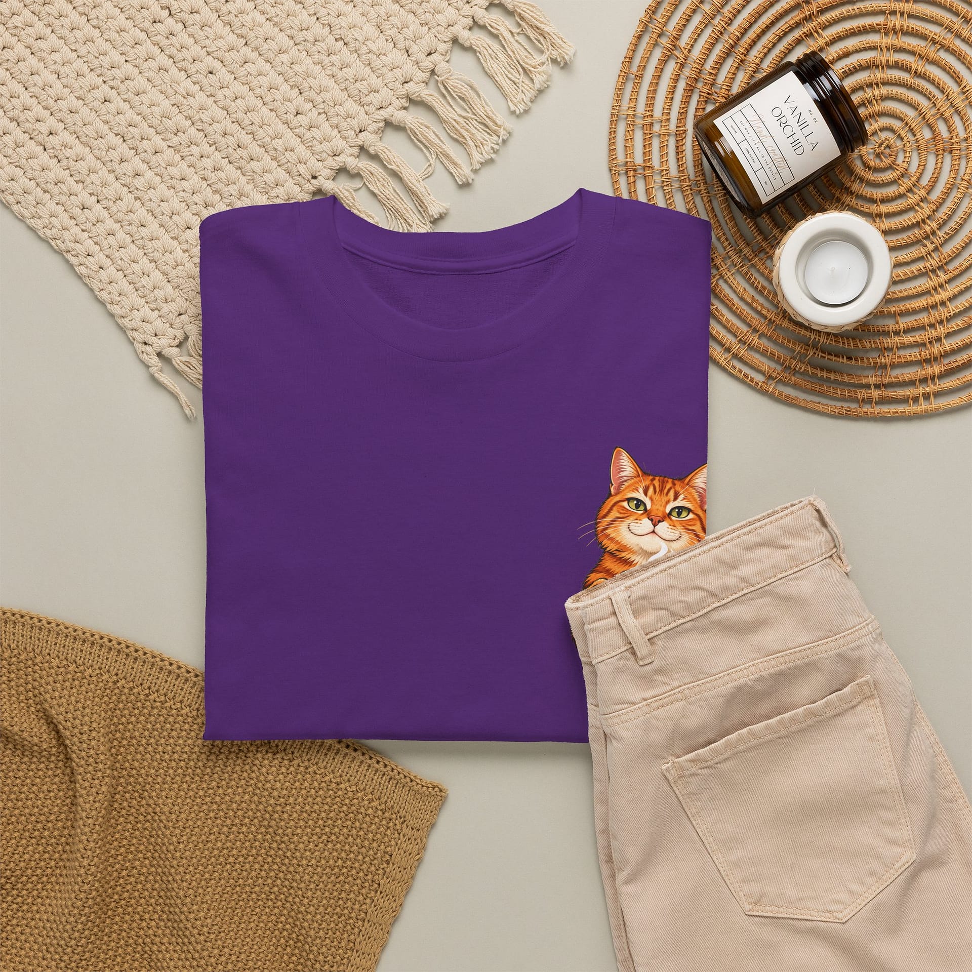 Close‑up of orange cat holding coffee mug graphic on T‑shirt